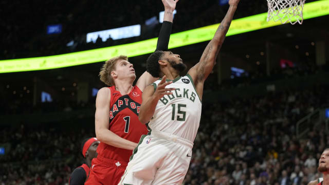 Milwaukee Bucks guard Cameron Payne (15) goes up to make a basket against Toronto Raptors guard Gradey Dick (1) 